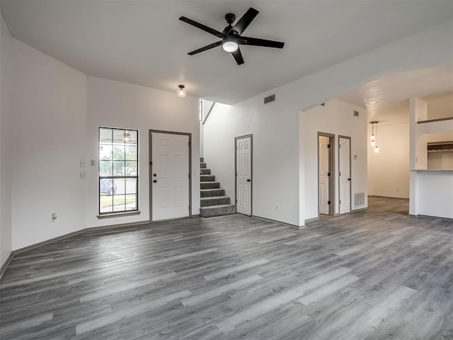 unfurnished living room featuring hardwood / wood-style flooring and ceiling fan