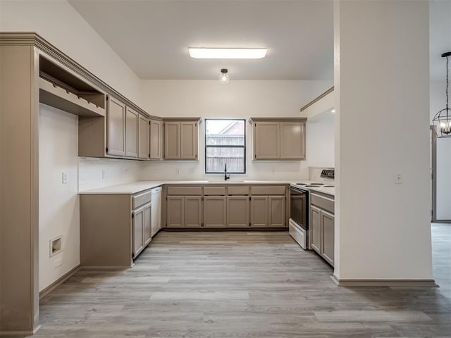 kitchen featuring range with electric stovetop, light hardwood / wood-style flooring, white dishwasher, and hanging light fixtures