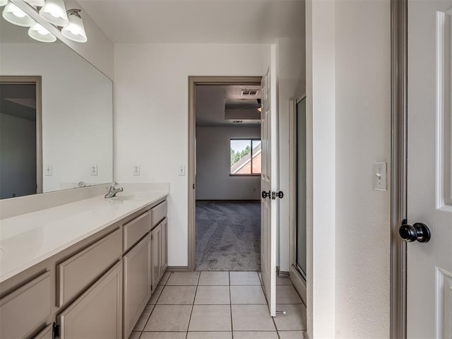 bathroom featuring tile patterned floors, vanity, and walk in shower