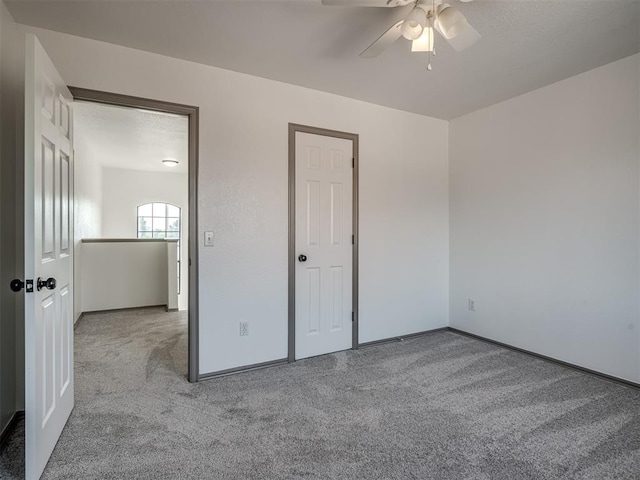 unfurnished bedroom with light colored carpet and ceiling fan