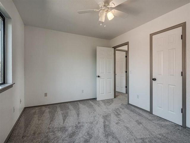 unfurnished bedroom featuring ceiling fan and light colored carpet