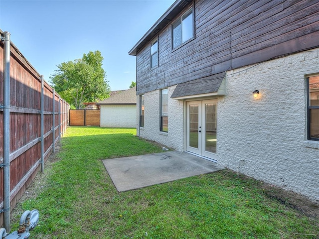 view of yard with a patio area and french doors