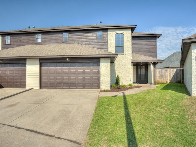 view of front property with a garage and a front yard