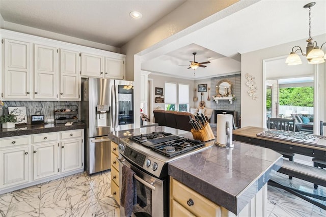 301 Club House Dr, Shawnee, OK 74801 - kitchen featuring appliances with stainless steel finishes, dark countertops, light marble finish floors, a ceiling fan, and recessed lighting