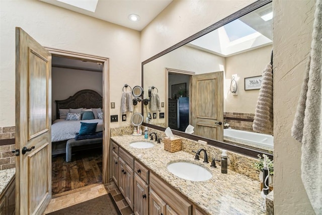 301 Club House Dr, Shawnee, OK 74801 - full bath featuring a skylight, connected bathroom, and double vanity
