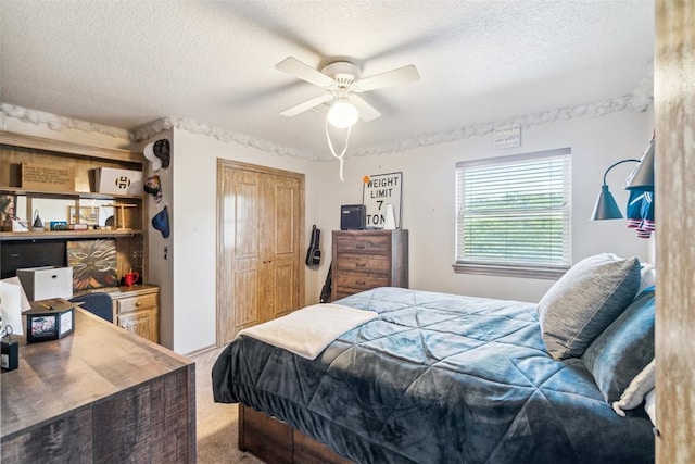 301 Club House Dr, Shawnee, OK 74801 - carpeted bedroom featuring a textured ceiling, a closet, and a ceiling fan