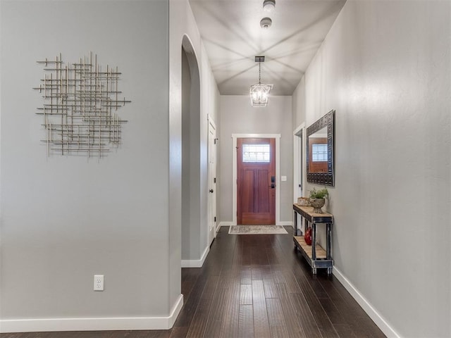 entryway featuring dark hardwood / wood-style flooring and an inviting chandelier