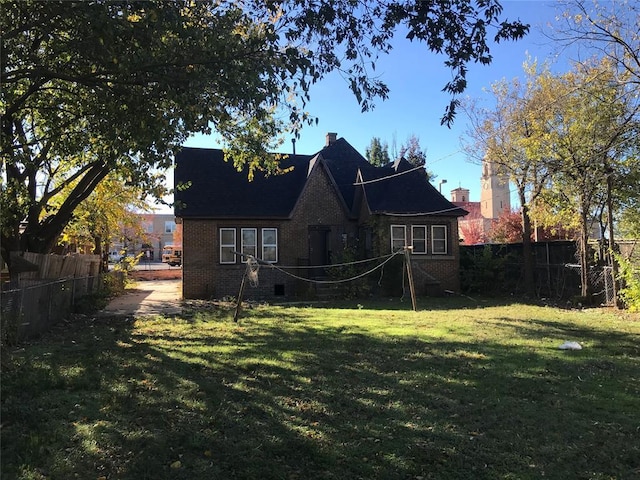 rear view of property with a yard