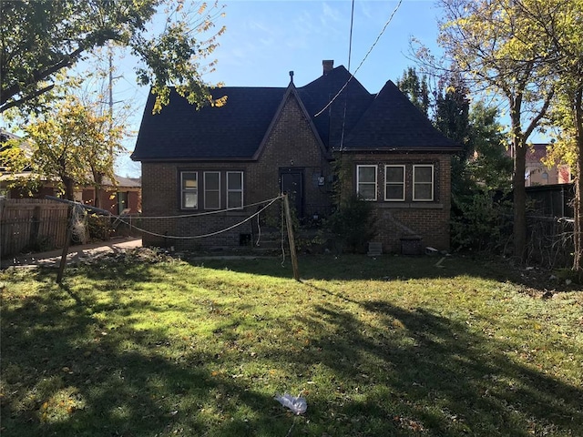 rear view of property with a yard