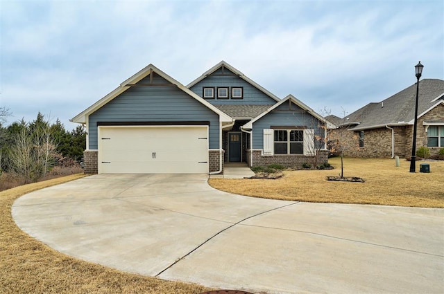 view of front of home with a front yard and a garage