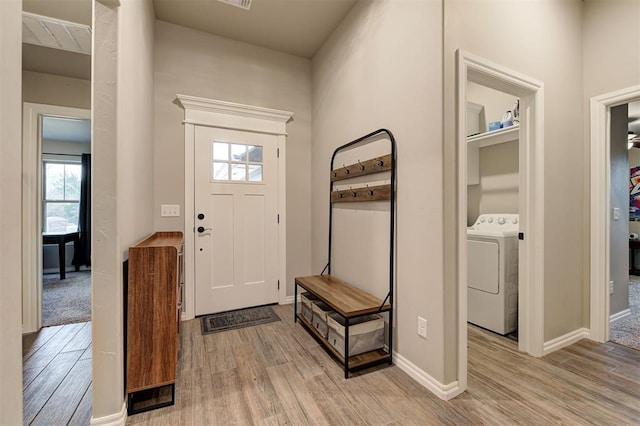 entrance foyer with washer / dryer and light wood-type flooring