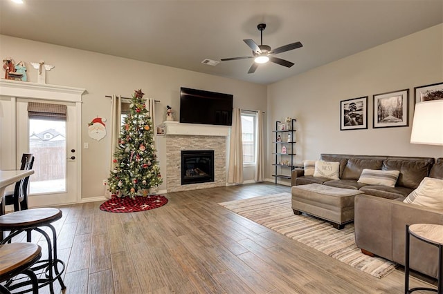 living room with ceiling fan, light hardwood / wood-style flooring, and a healthy amount of sunlight