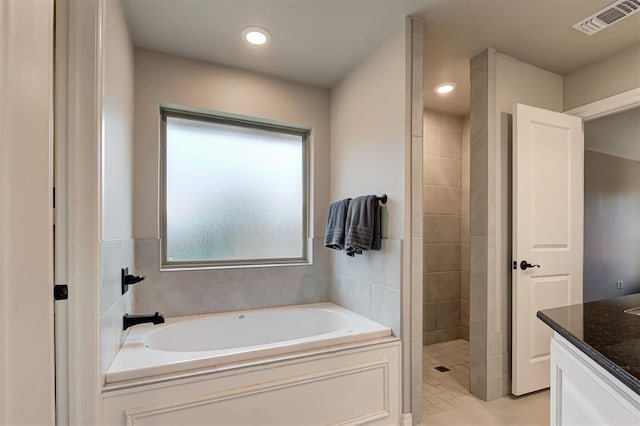 bathroom featuring separate shower and tub, tile patterned floors, and vanity