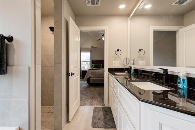 bathroom featuring tile patterned floors, vanity, ceiling fan, and tiled shower