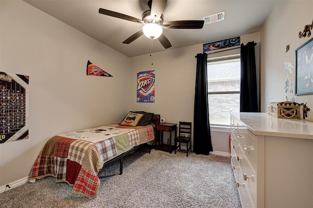 carpeted bedroom with multiple windows and ceiling fan