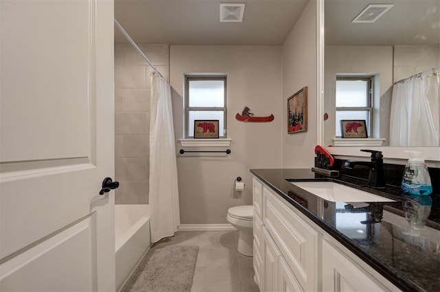 full bathroom with tile patterned floors, shower / bathtub combination with curtain, vanity, and toilet