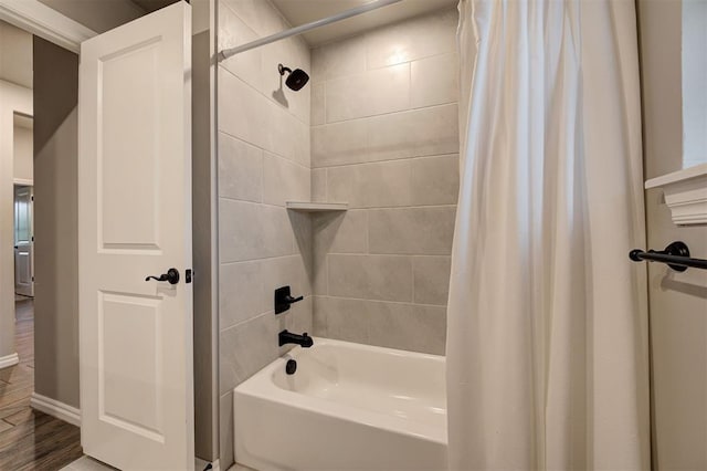 bathroom featuring hardwood / wood-style floors and shower / bath combo