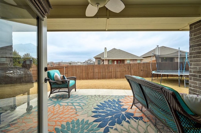 view of patio / terrace with ceiling fan and a trampoline