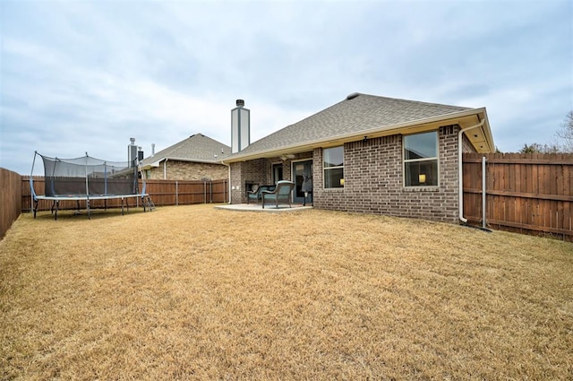 rear view of house featuring a patio area and a trampoline