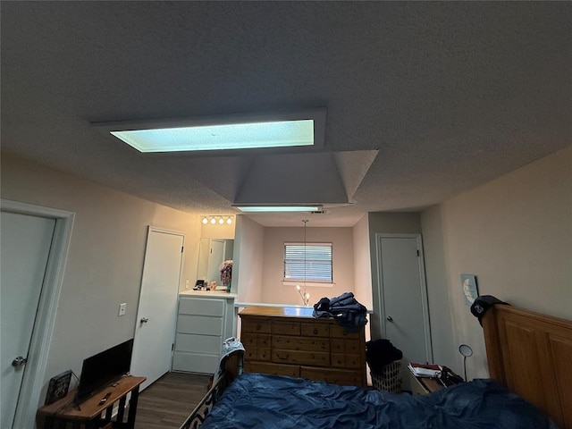 bedroom with hardwood / wood-style flooring and a textured ceiling