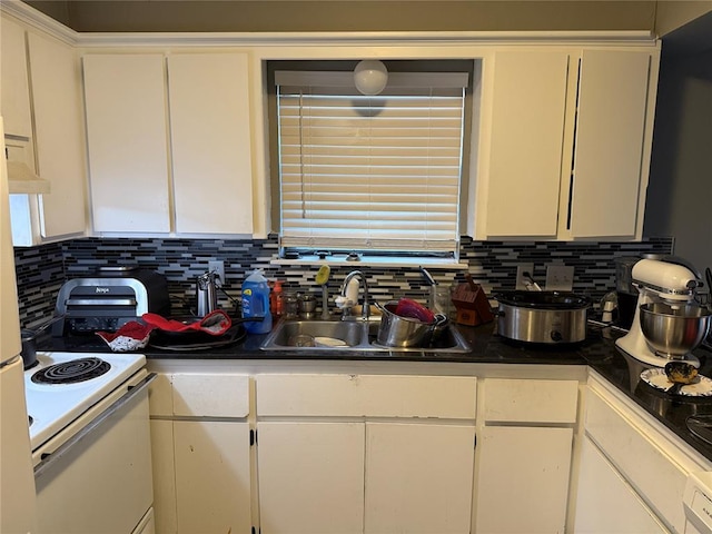 kitchen featuring sink, white cabinets, electric range, and tasteful backsplash