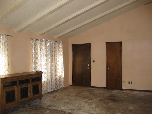 spare room featuring lofted ceiling with beams