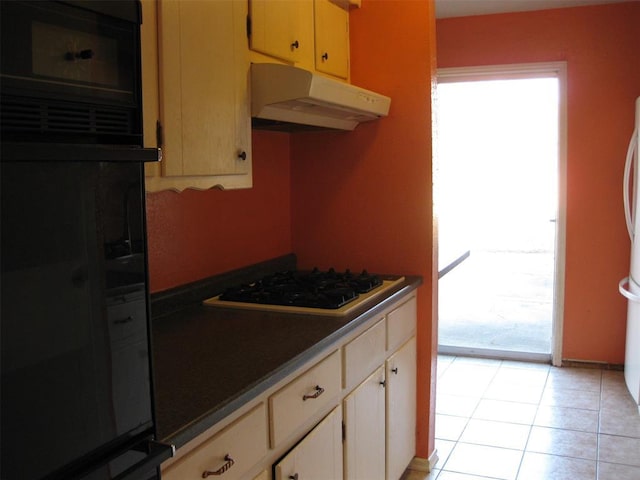 kitchen with white appliances and light tile patterned floors