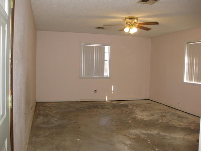 spare room with ceiling fan and a textured ceiling