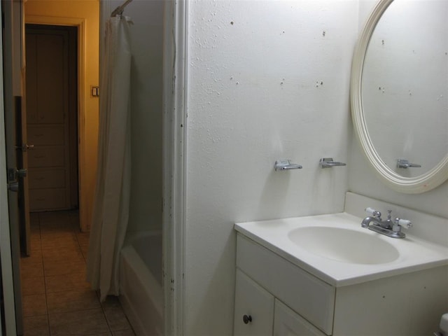 bathroom featuring tile patterned floors, shower / bath combination with curtain, and vanity