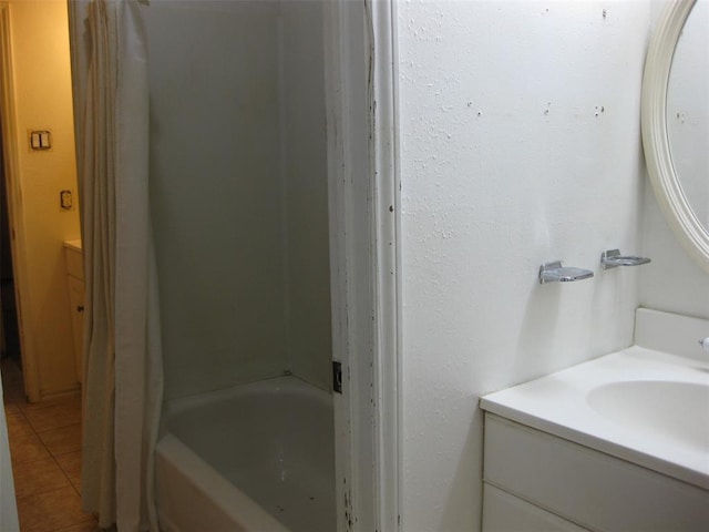 bathroom featuring vanity, tile patterned floors, and a tub