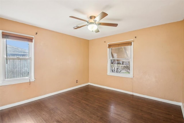 unfurnished room featuring ceiling fan, plenty of natural light, and dark hardwood / wood-style floors