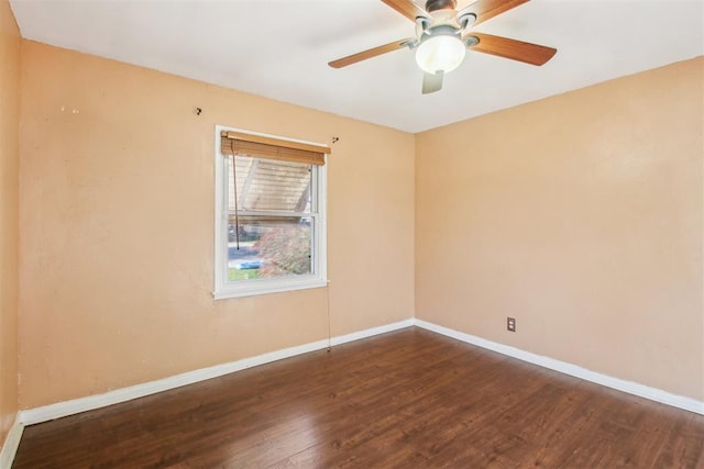 spare room with dark hardwood / wood-style floors and ceiling fan