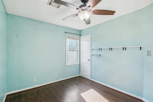 empty room with dark hardwood / wood-style flooring