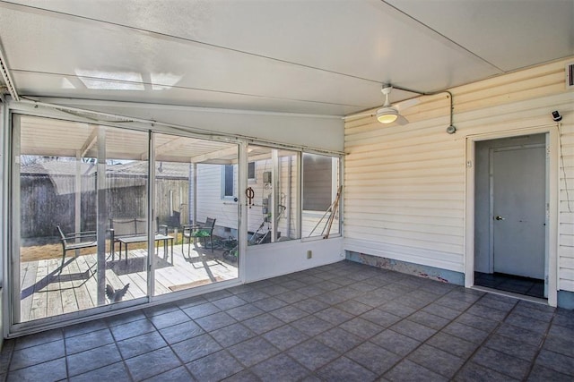 unfurnished sunroom featuring vaulted ceiling