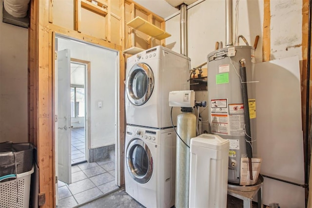 washroom featuring tile patterned floors, gas water heater, and stacked washer / dryer