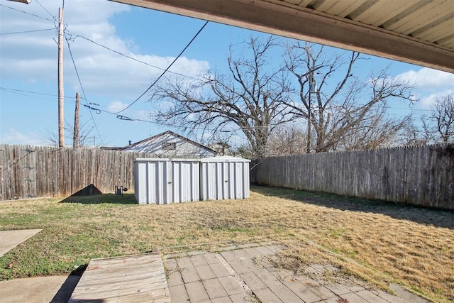 view of yard featuring a storage unit and a patio area