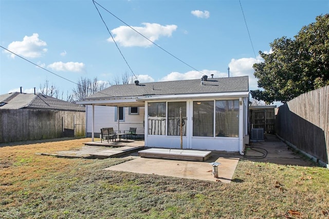 back of house with a sunroom, cooling unit, a patio, and a lawn