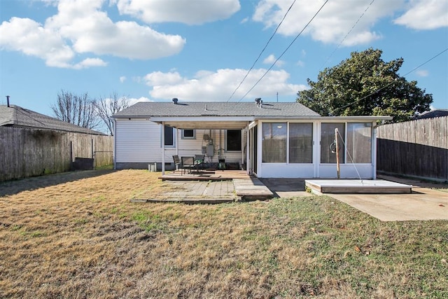 rear view of house with a patio area, a sunroom, a yard, and a wooden deck