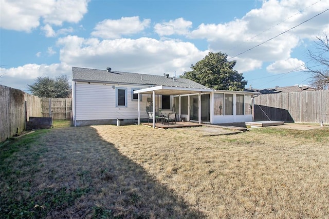 rear view of property with a lawn, a sunroom, and a patio area