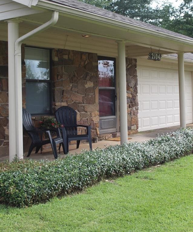 entrance to property with a lawn