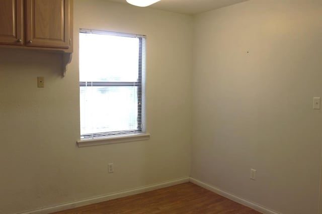 spare room featuring hardwood / wood-style floors and a wealth of natural light