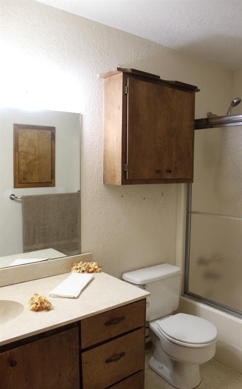 full bathroom featuring vanity, toilet, and enclosed tub / shower combo