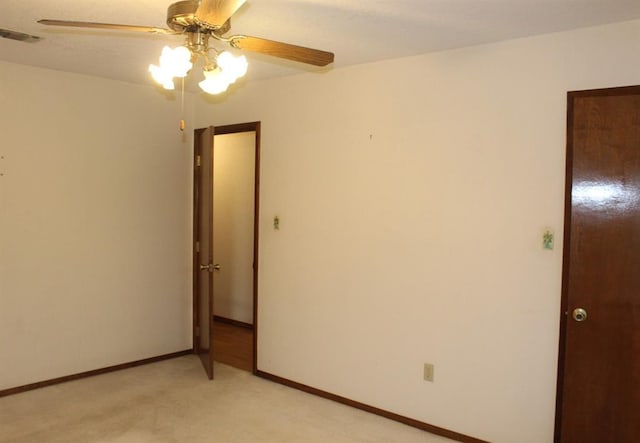 unfurnished room with ceiling fan and light colored carpet