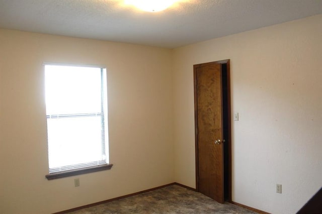 carpeted empty room featuring a healthy amount of sunlight