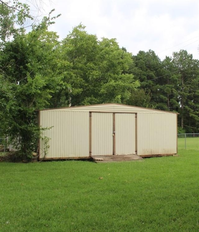 view of outbuilding featuring a yard