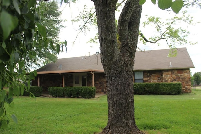 rear view of house with a yard