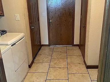 hallway featuring washing machine and dryer