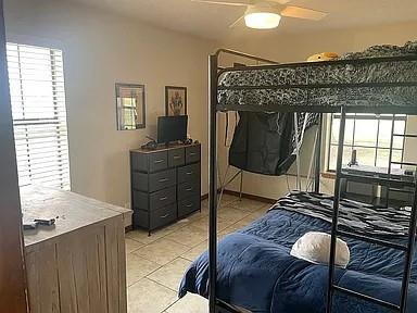 bedroom featuring ceiling fan and light tile patterned flooring