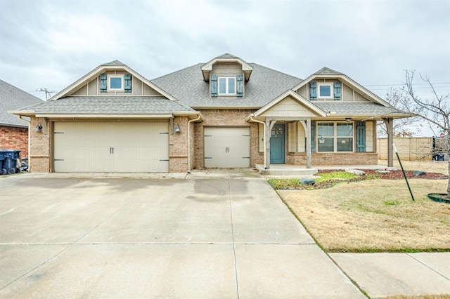 view of front of home with a garage and a front lawn