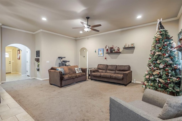 tiled living room featuring ceiling fan and ornamental molding